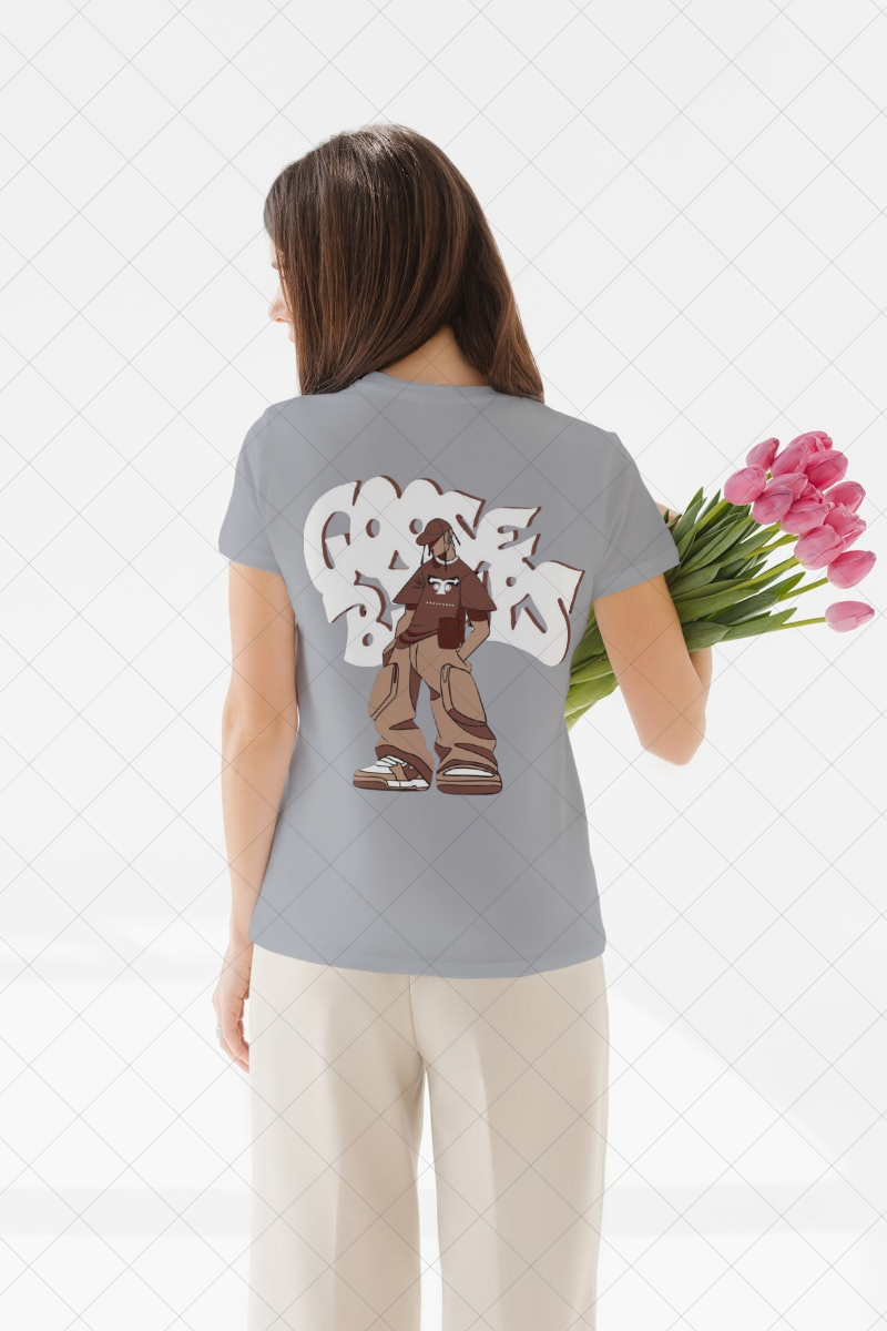 Person wearing a gray t-shirt with a graphic design, holding pink tulips on a light background